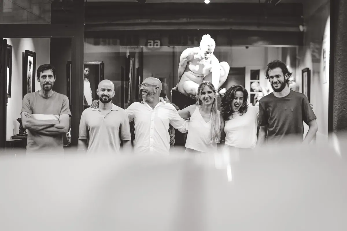 The Galerie Calderone team in the gallery, in front of a plaster sculpture